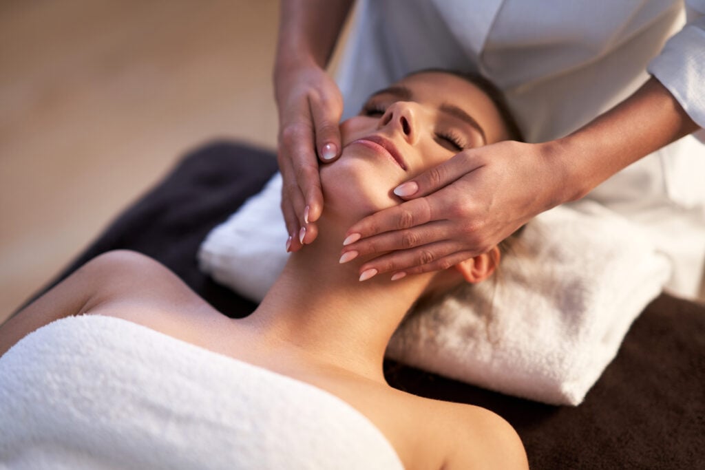 Relaxed woman receiving back massage